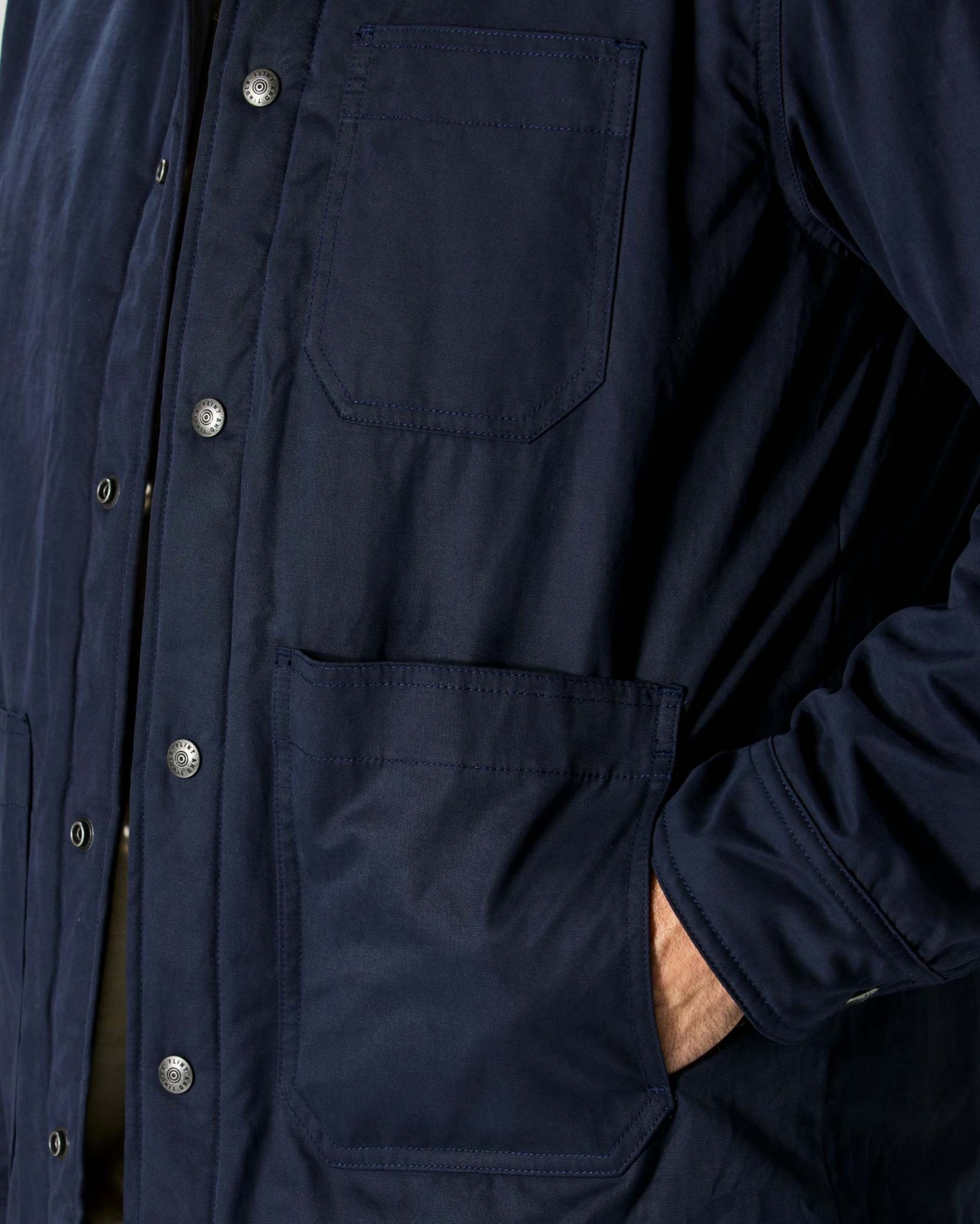 hand in pocket of a blue jacket