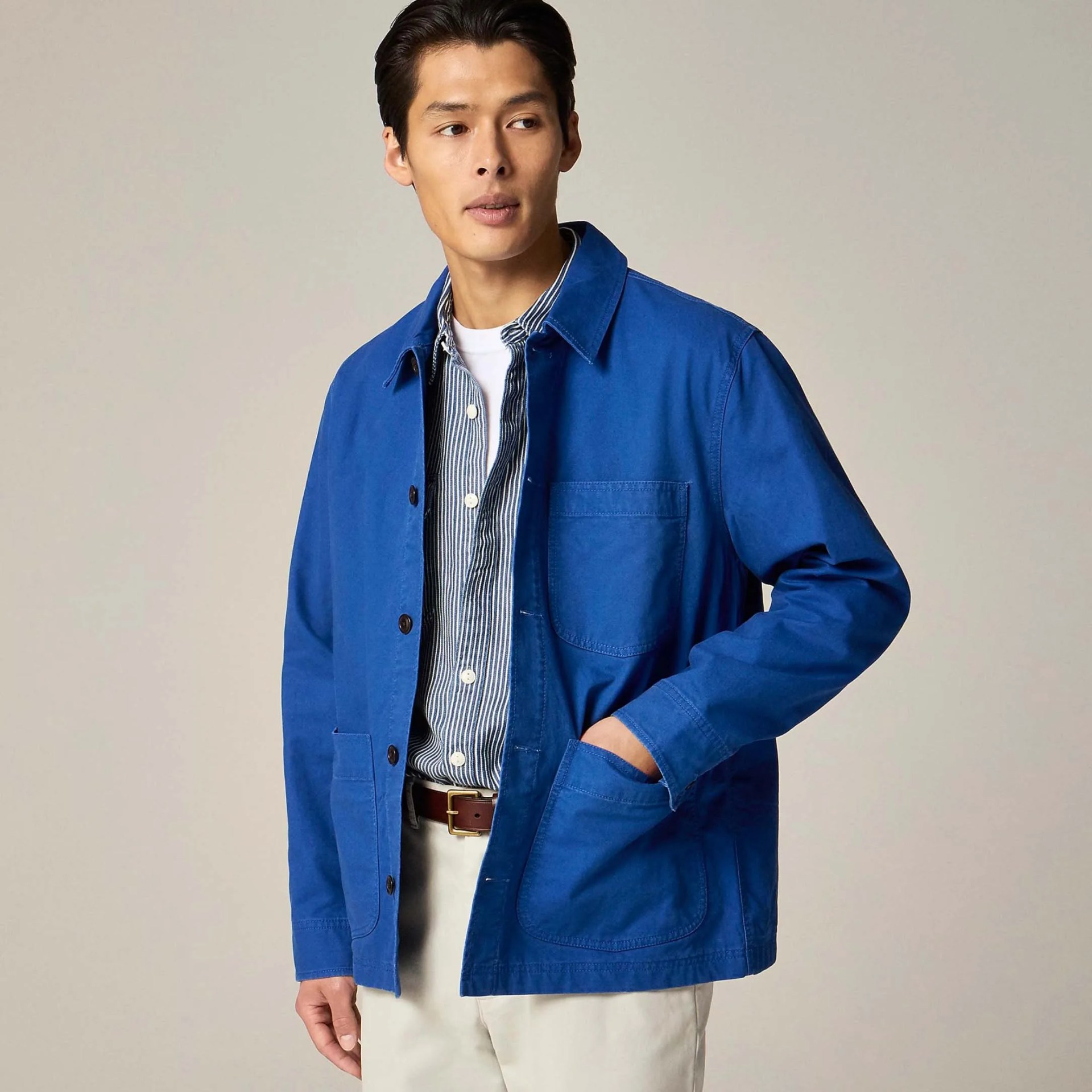a man in a french blue chore coat