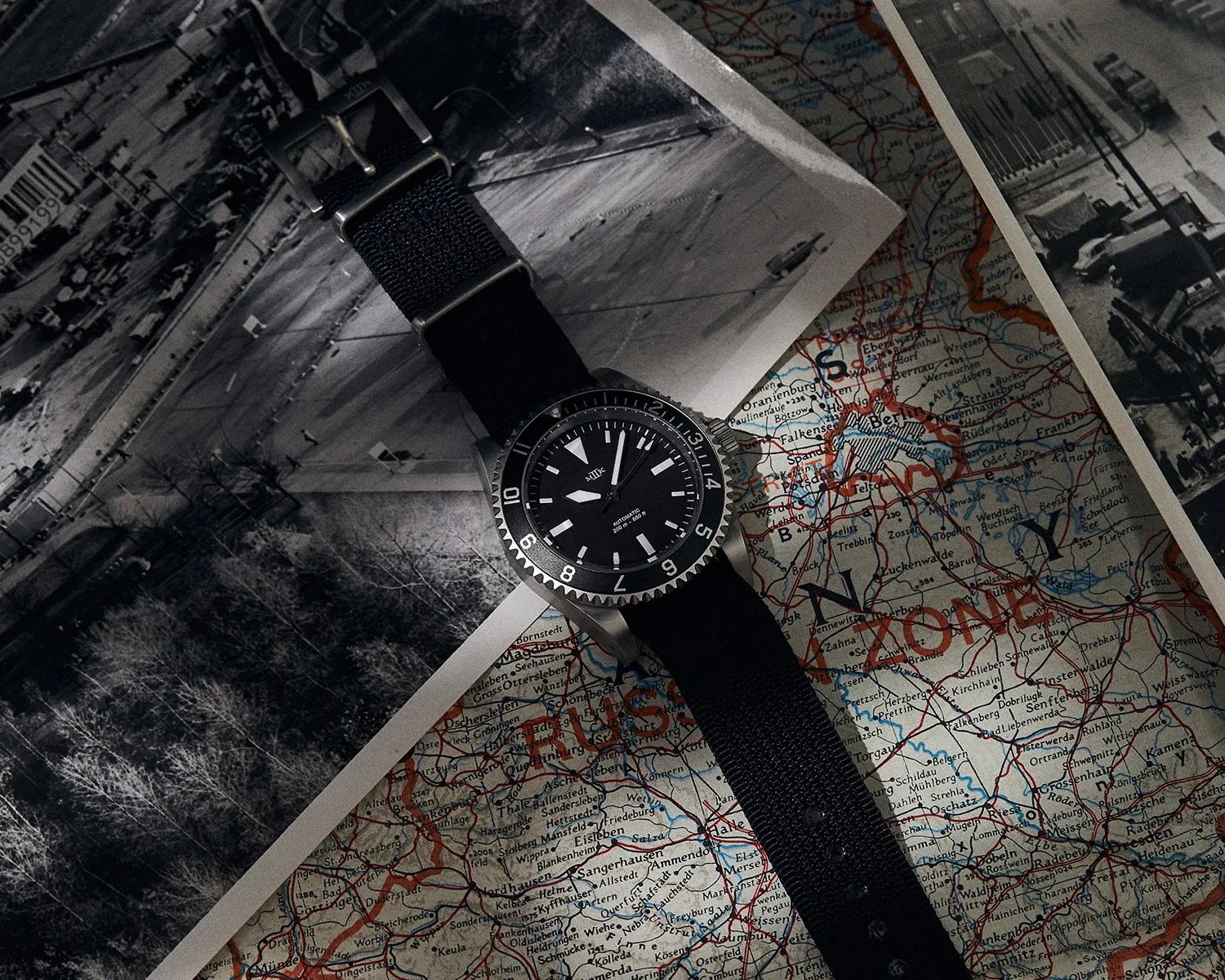 a Mk II dive watch on a map