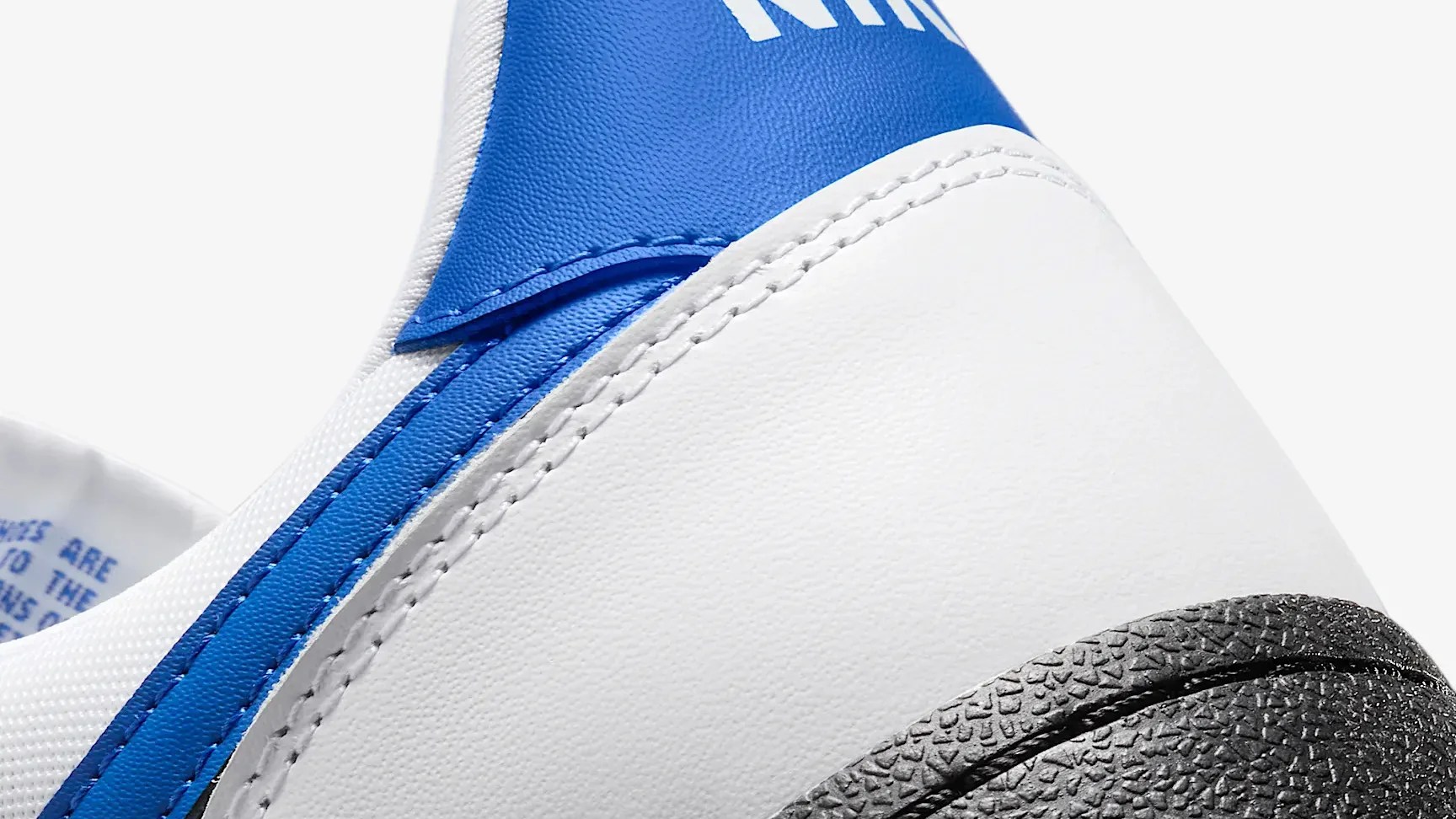 white and blue nike sneaker