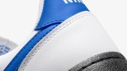 white and blue nike sneaker