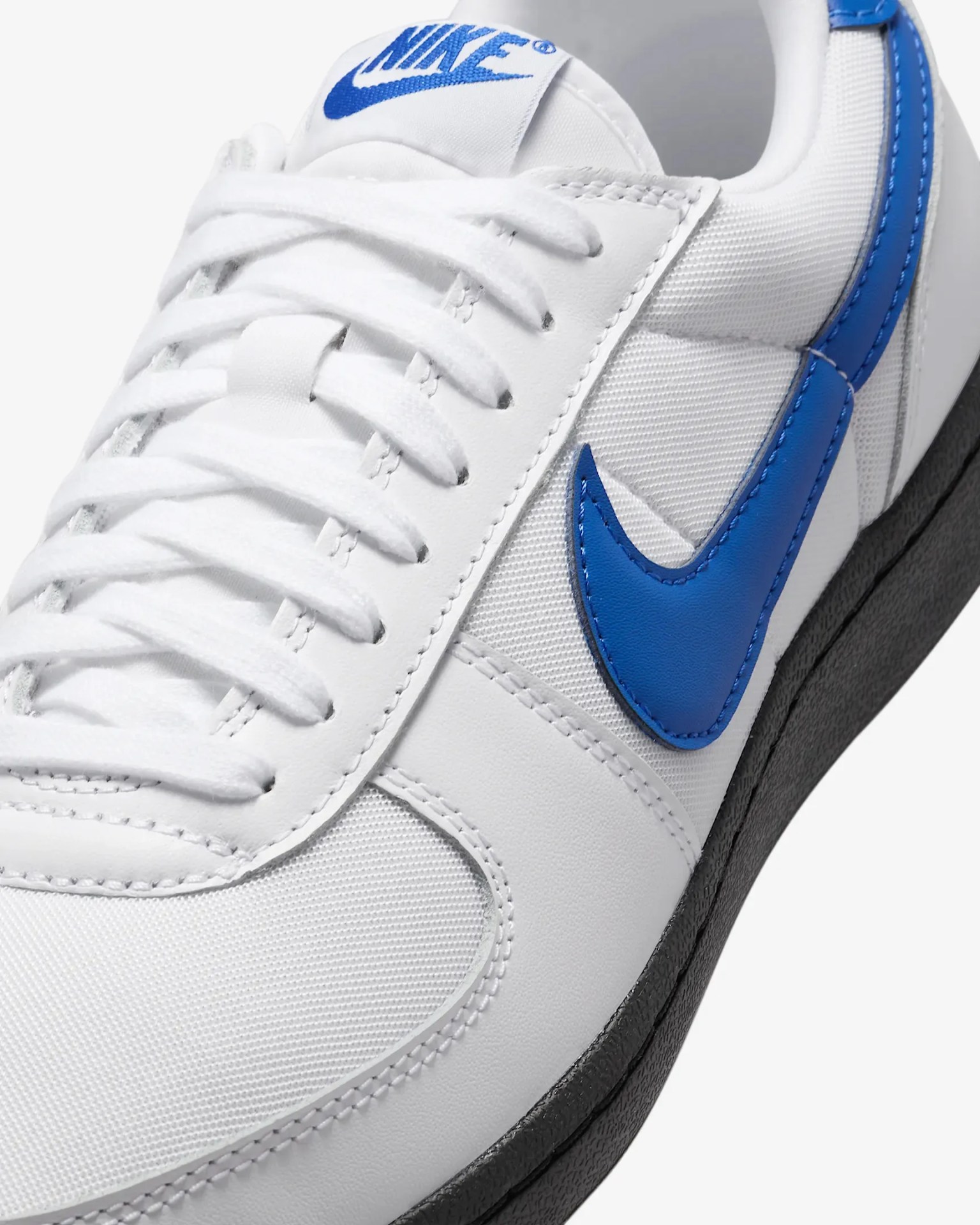 white and blue nike sneaker