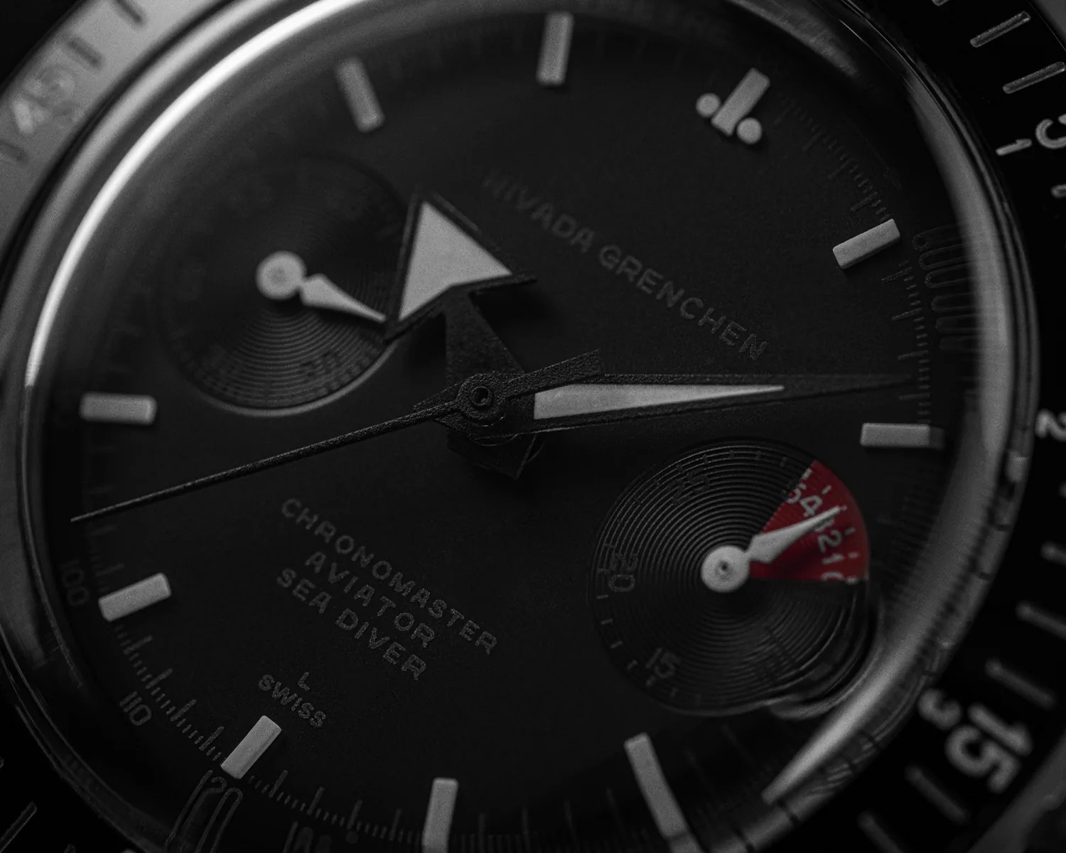 a closeup of a black nivada grenchen watch dial