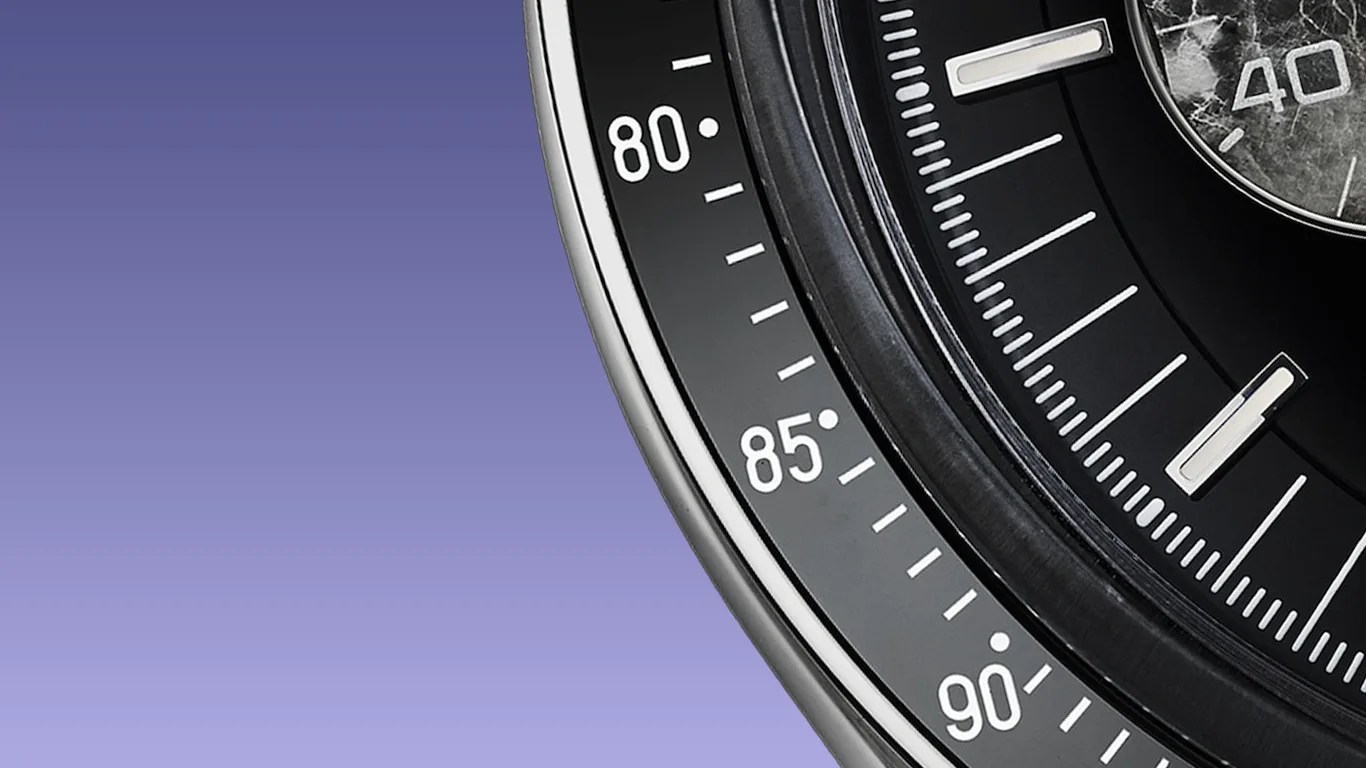 a closeup of the bezel on an omega speedmaster watch