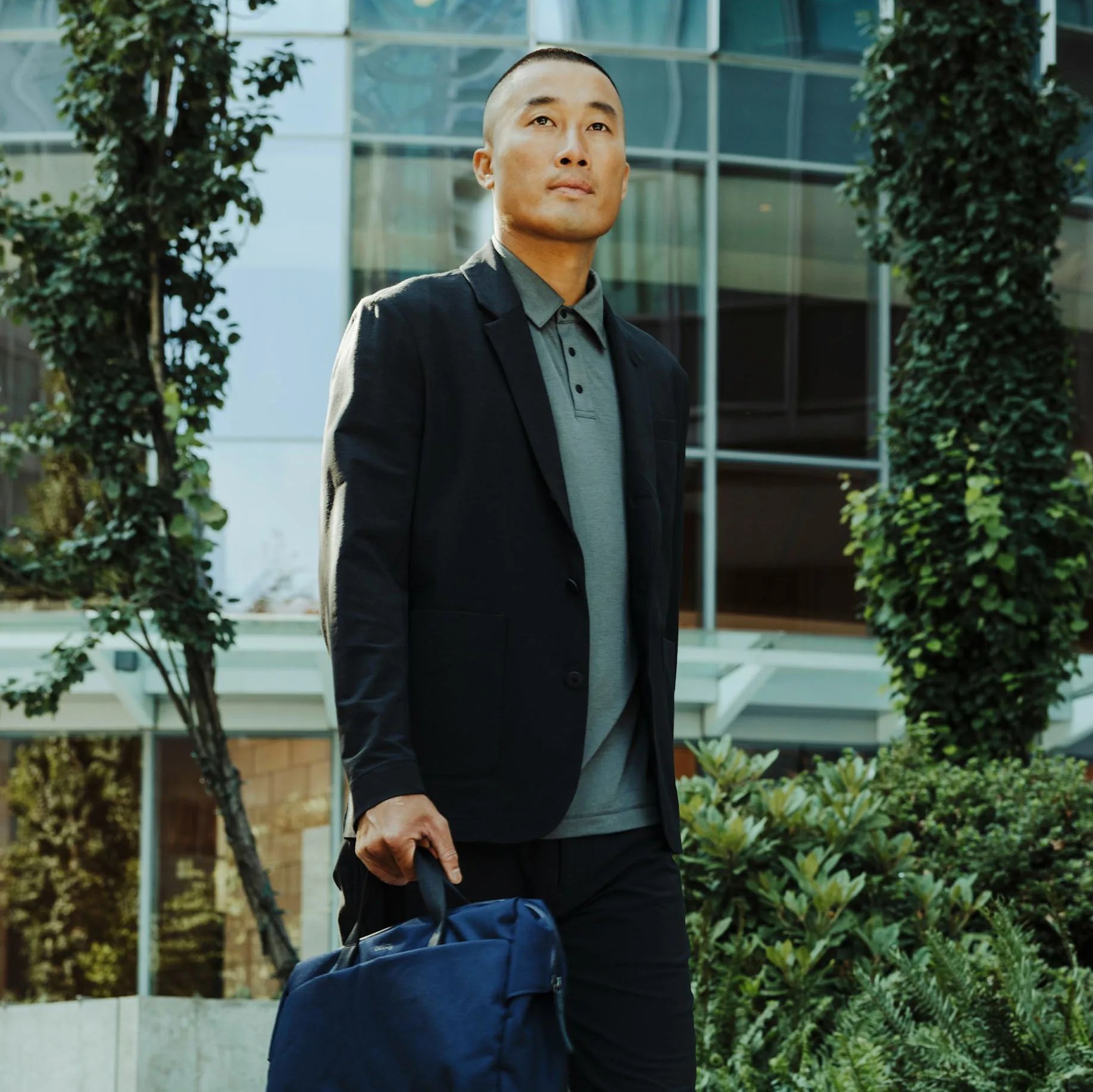 a man in a black jacket and polo shirt
