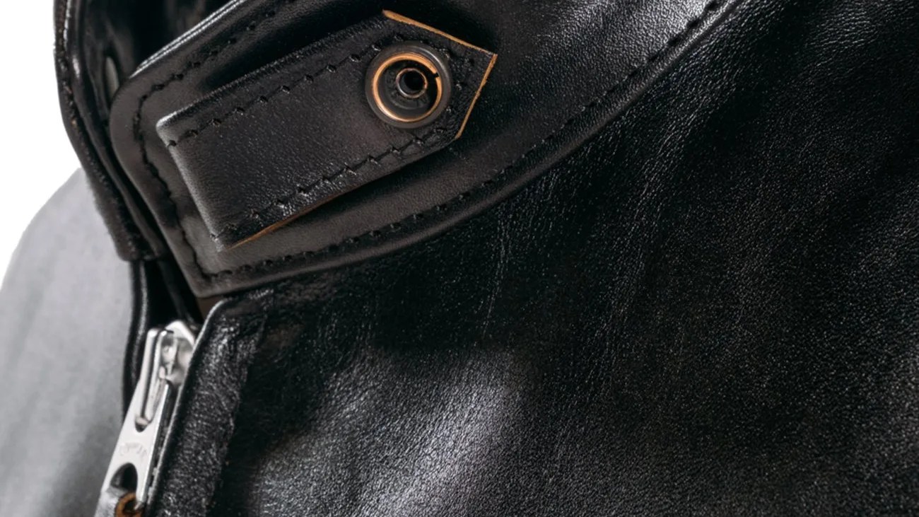 the throat latch on a Schott cafe racer black leather jacket