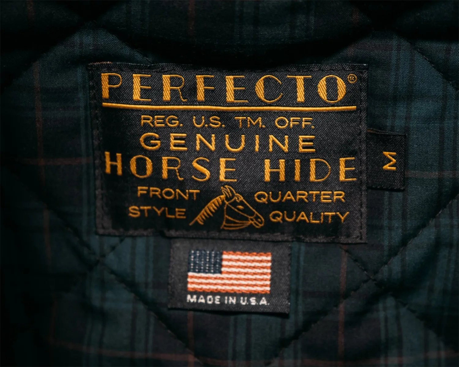 clothing tag that reads perfecto genuine horse hide front quarter style quality made in U S A