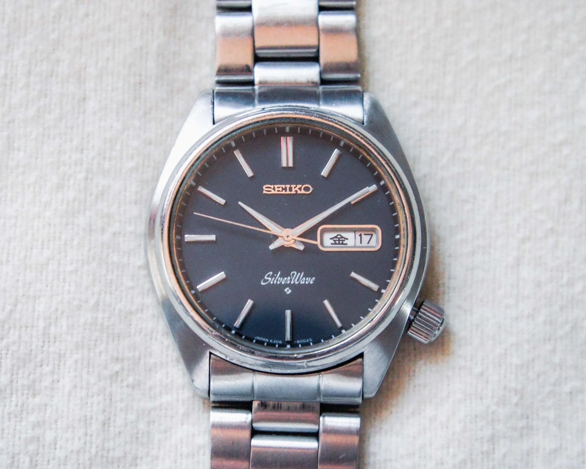a steel watch with a blue dial