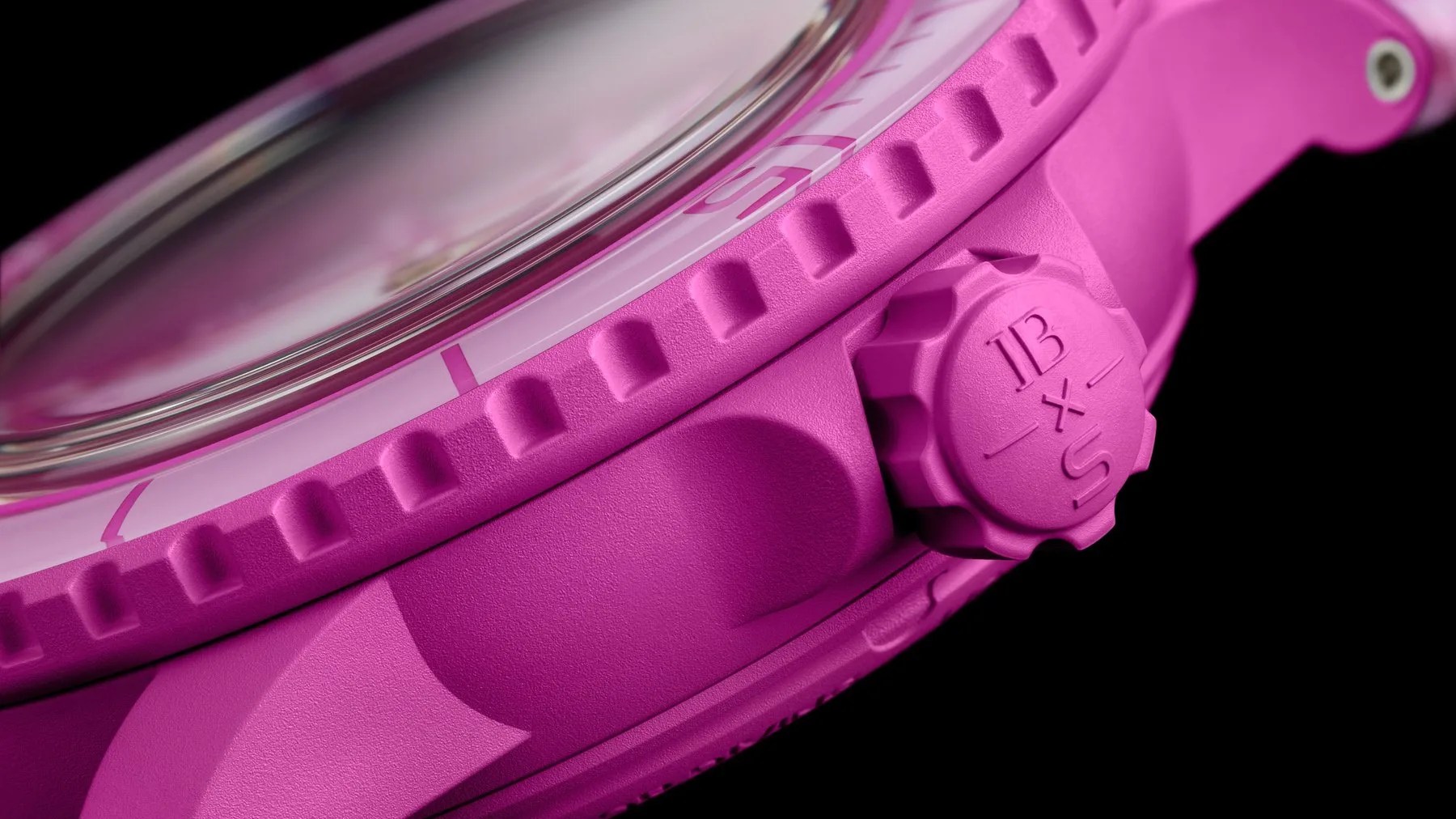 the side and crown of a pink watch