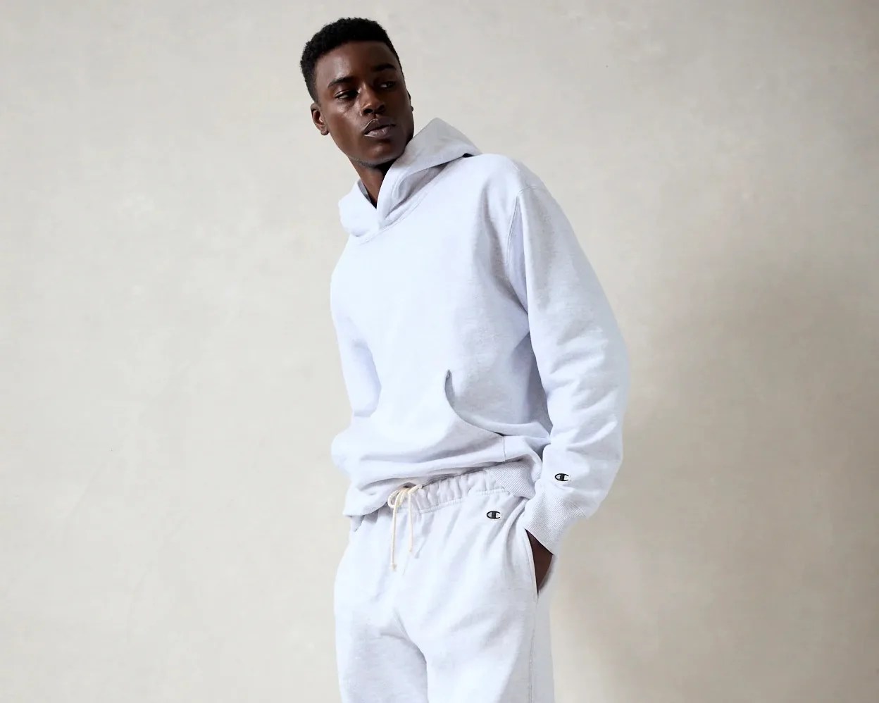 a man wearing gray Champion hoodie and sweatpants