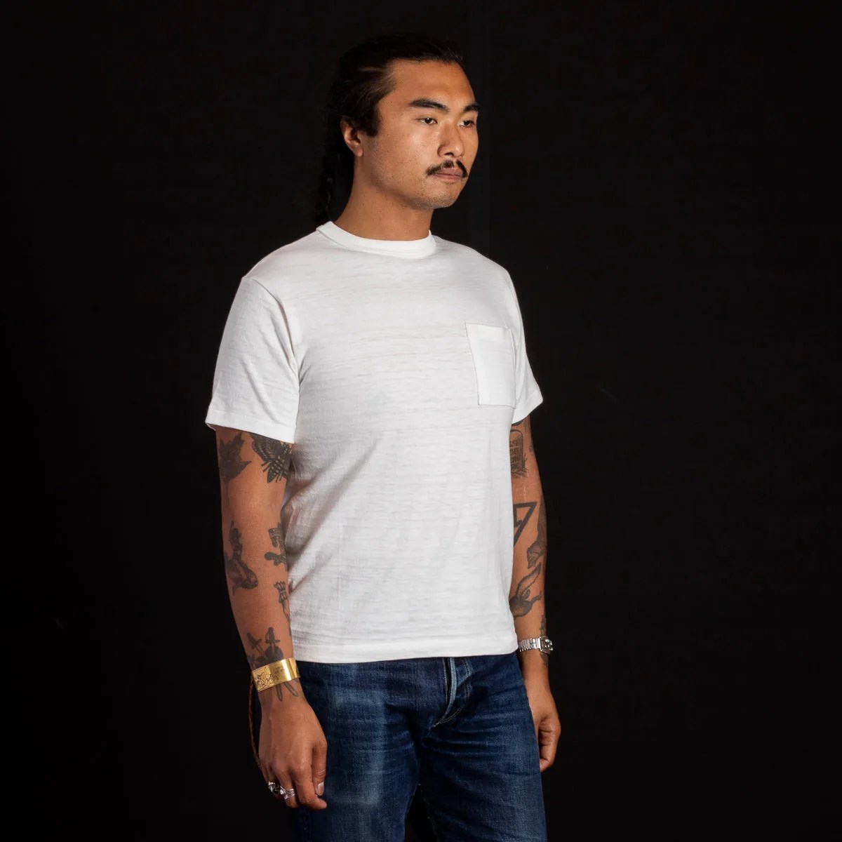 a man wearing a slub cotton white pocket t shirt.