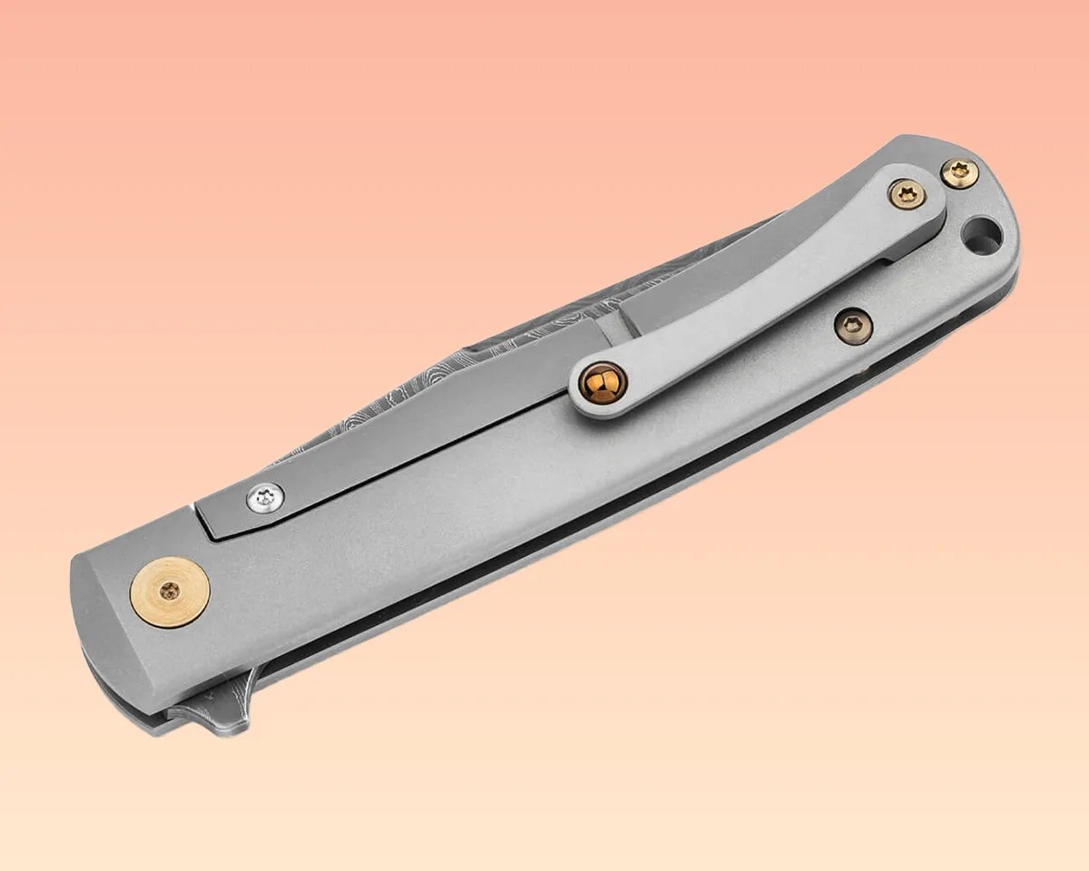 Böker Damast Annual Knife 2025 on peach background.