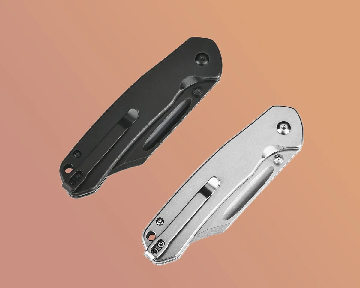 Two CJRB Bowie Pyrite knives on a sand-colored background