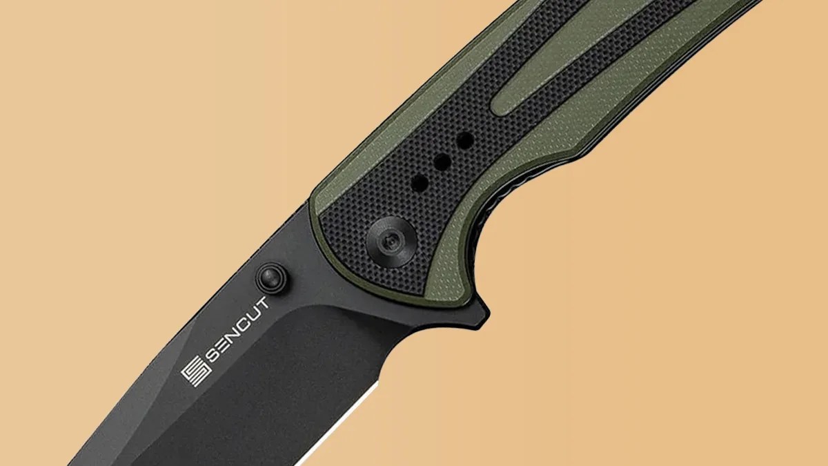 Closeup of Sencut Regnator knife on tan background