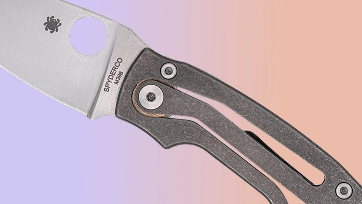 Closeup of Spyderco PITS 2 Slipit knife on pink-purple background