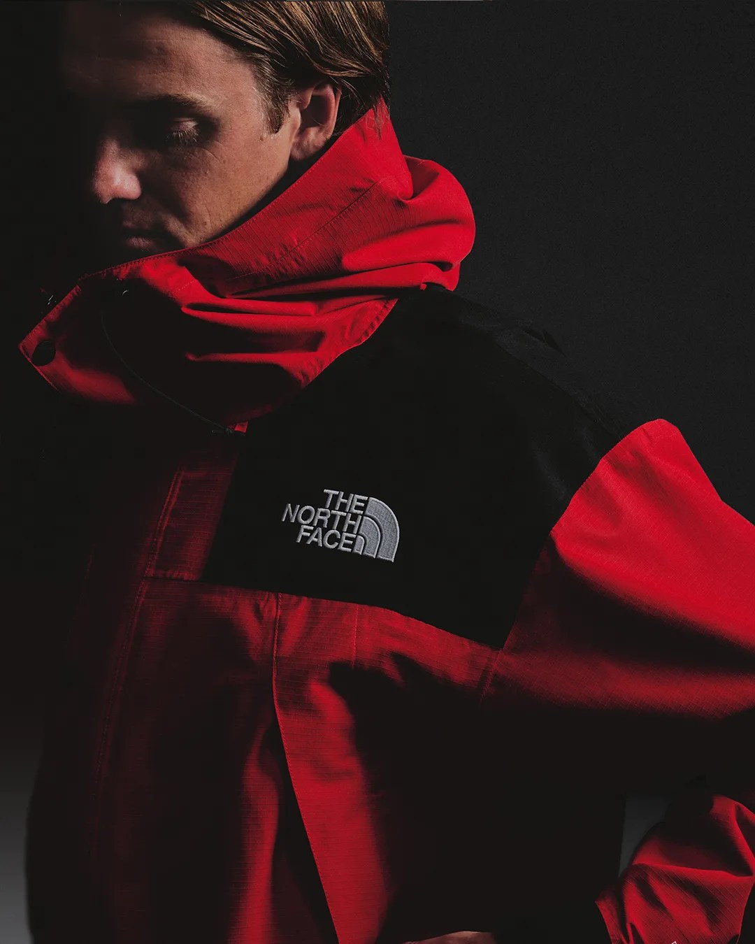 man wearing The North Face Mono Jacket in red