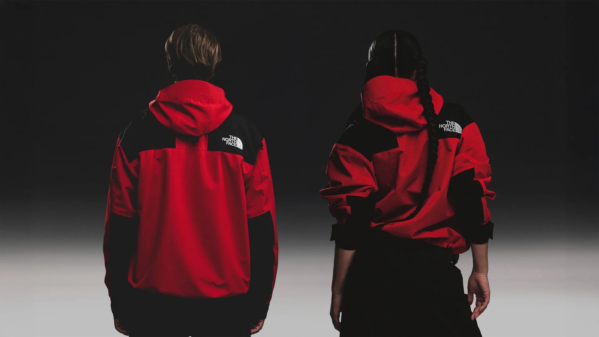 back of a man and woman wearing The North Face Dryvent Mono Jacket in red
