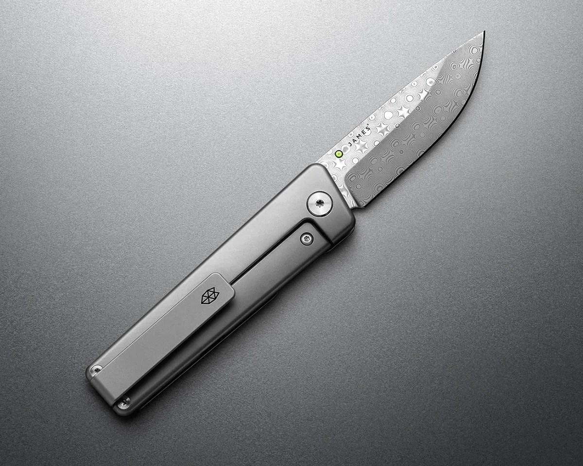 The James Brand Chapter 2 Rose Damasteel knife on gray background (lock side)