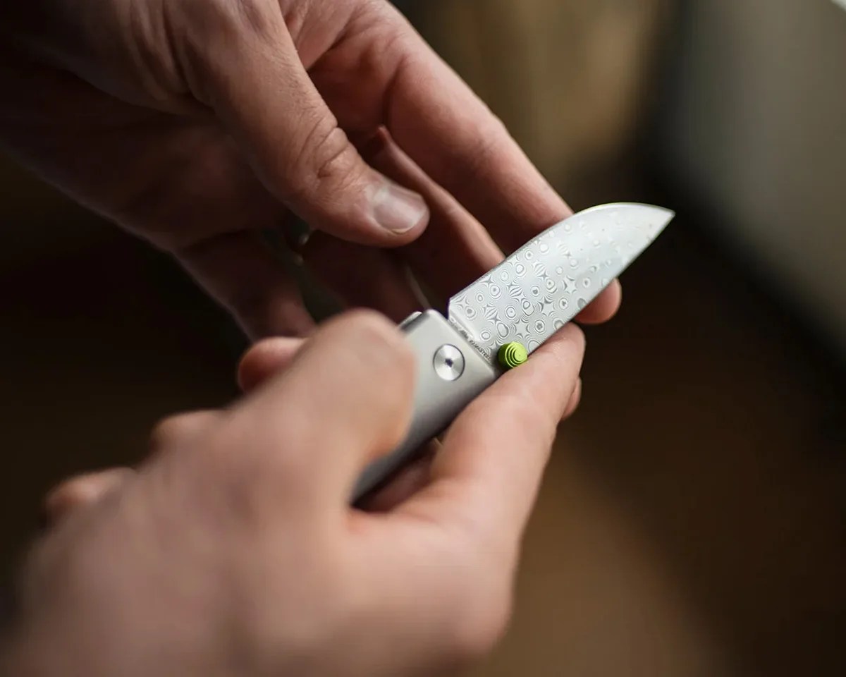 The James Brand Chapter 2 Rose Damasteel knife in person's hands