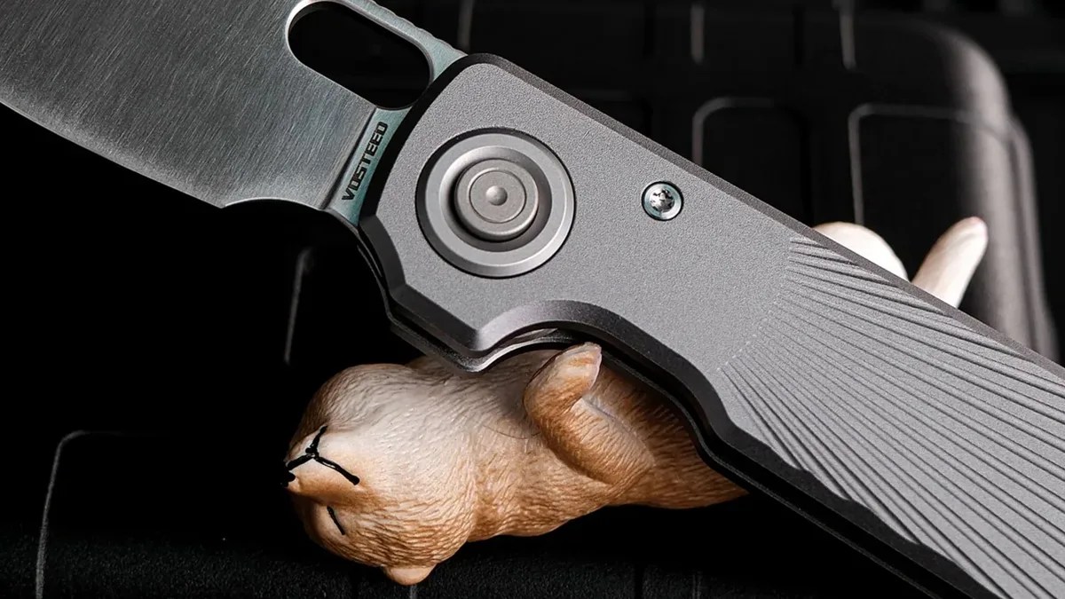 Vosteed Akita knife closeup with toy dog
