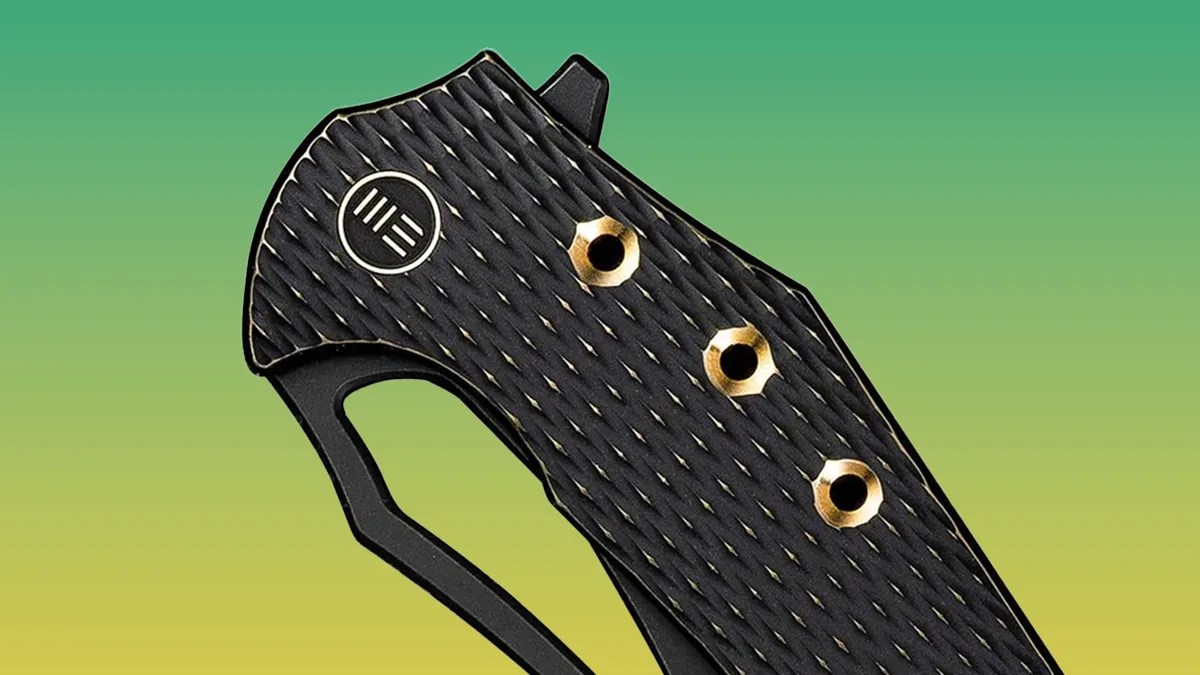 We Knife Epaulette knife closeup on green-yellow background