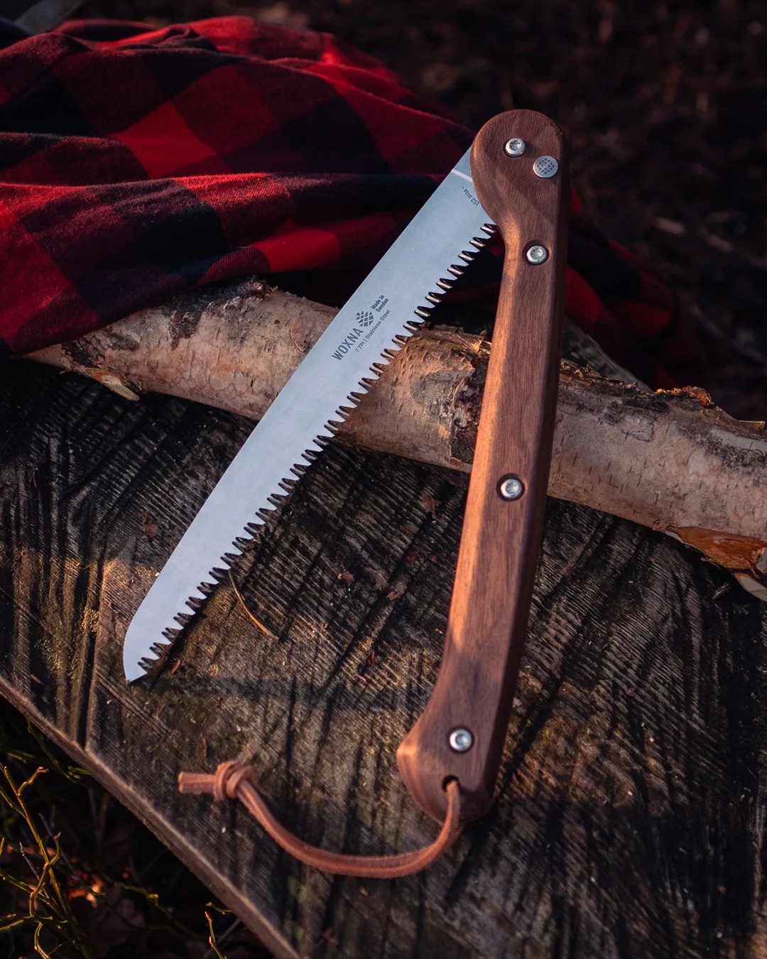 Woxna Folding Saw on log with flannel blanket