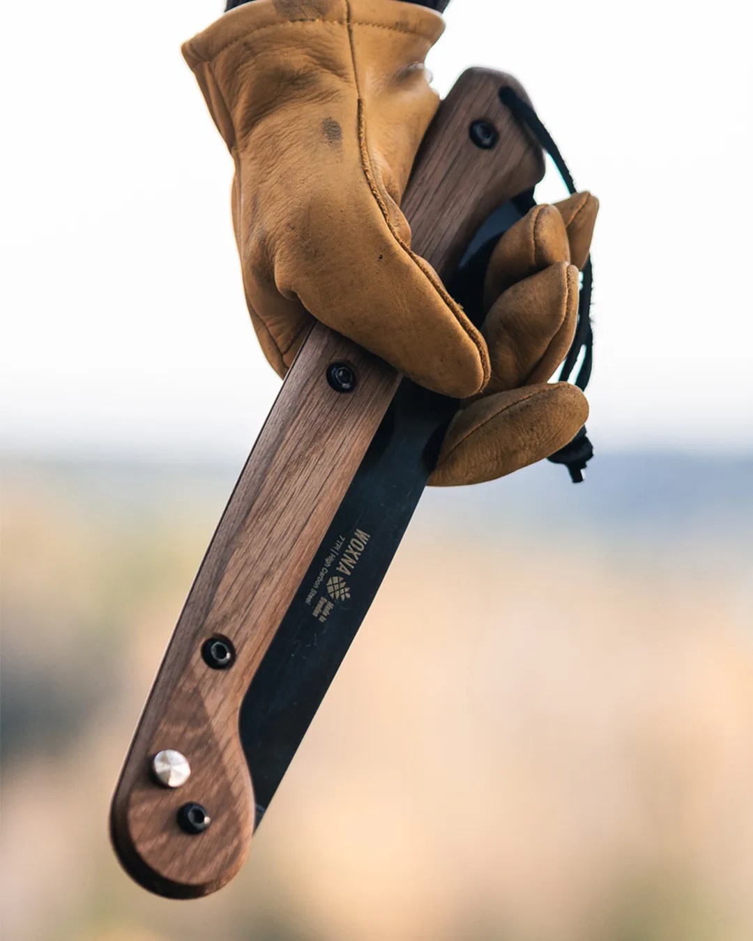 Woxna Folding Saw in gloved hand