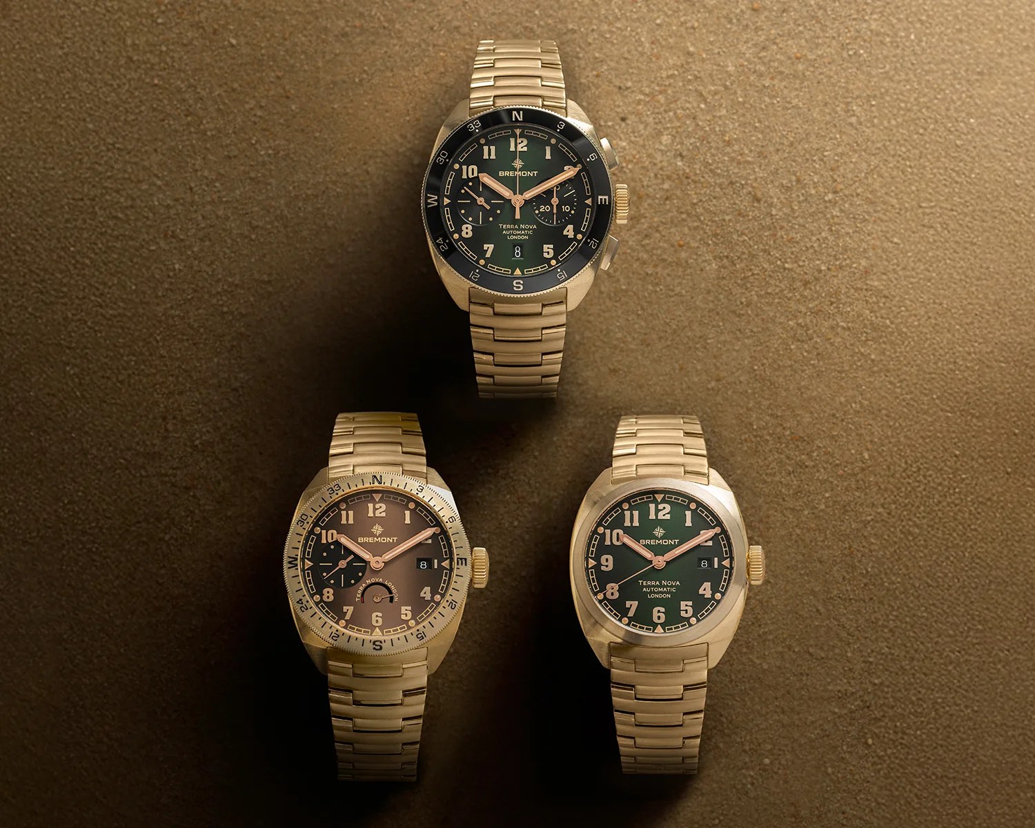 three bremont bronze watches in sand