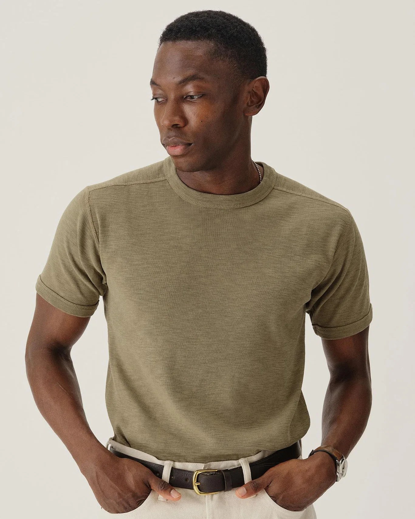 a man in a green buck mason t-shirt