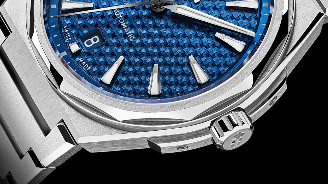 the bezel and case of a steel watch with a blue dial