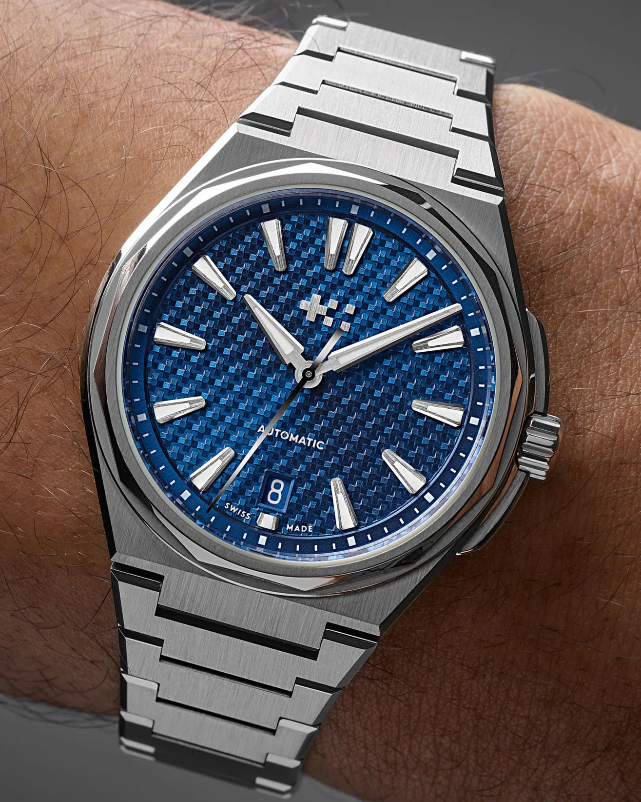 a steel watch on a man's wrist