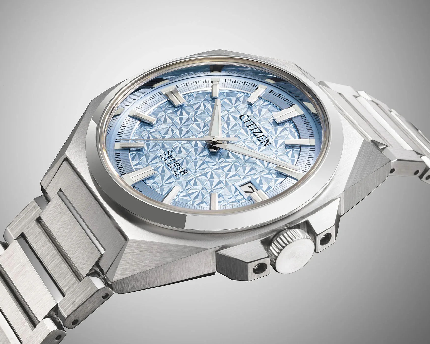 a steel watch with a light blue face