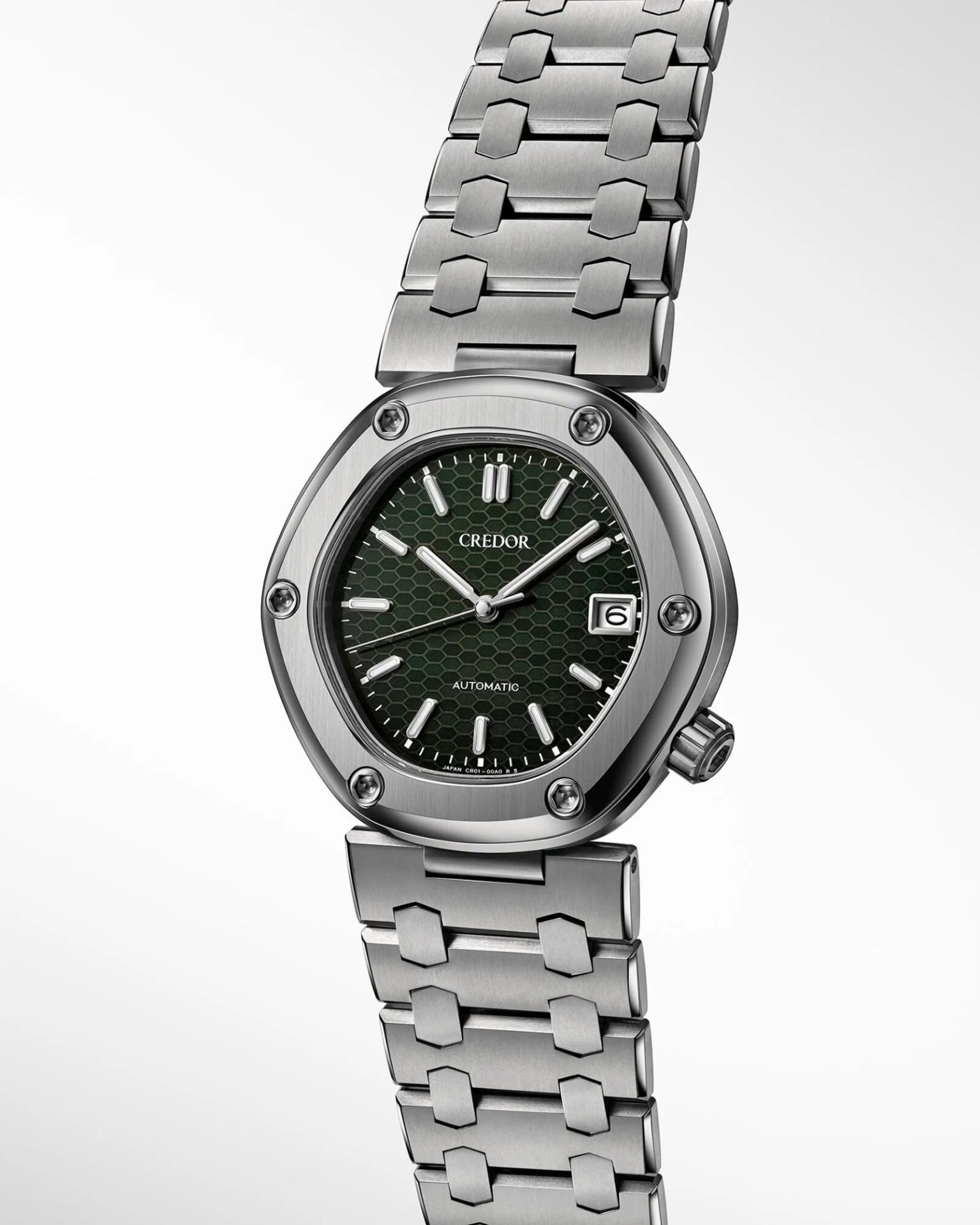 a titanium watch with a hexagonal case and green dial