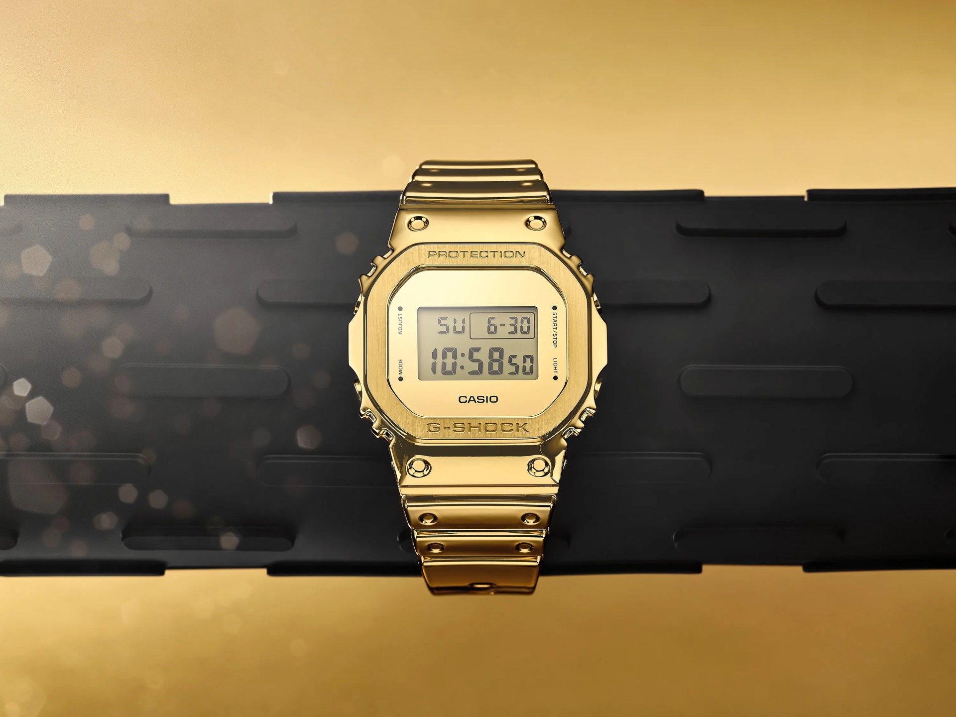 casio gold watch resting on a rubber bar