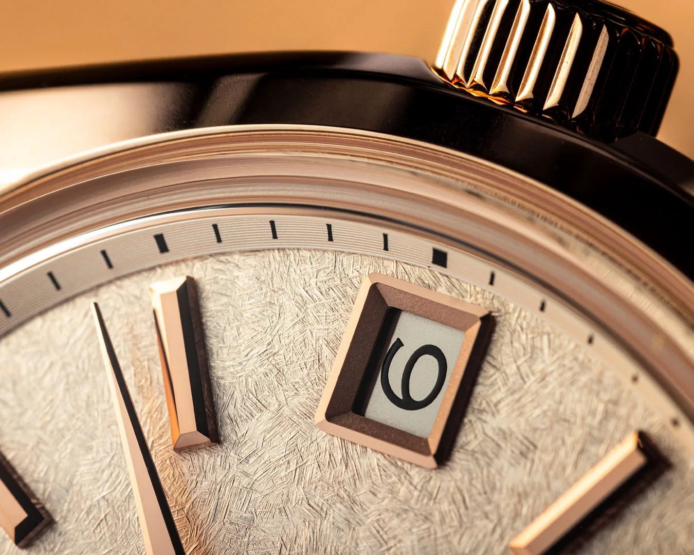 the dial texture and date window on a gold Grand Seiko watch
