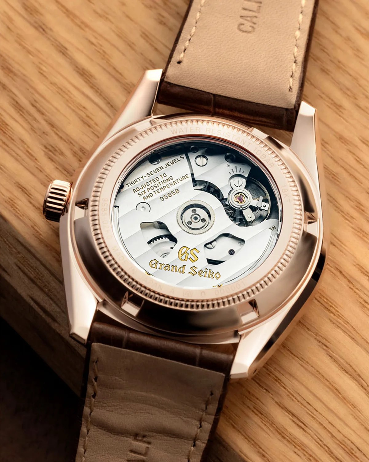 the display case back of a gold Gran Seiko watch