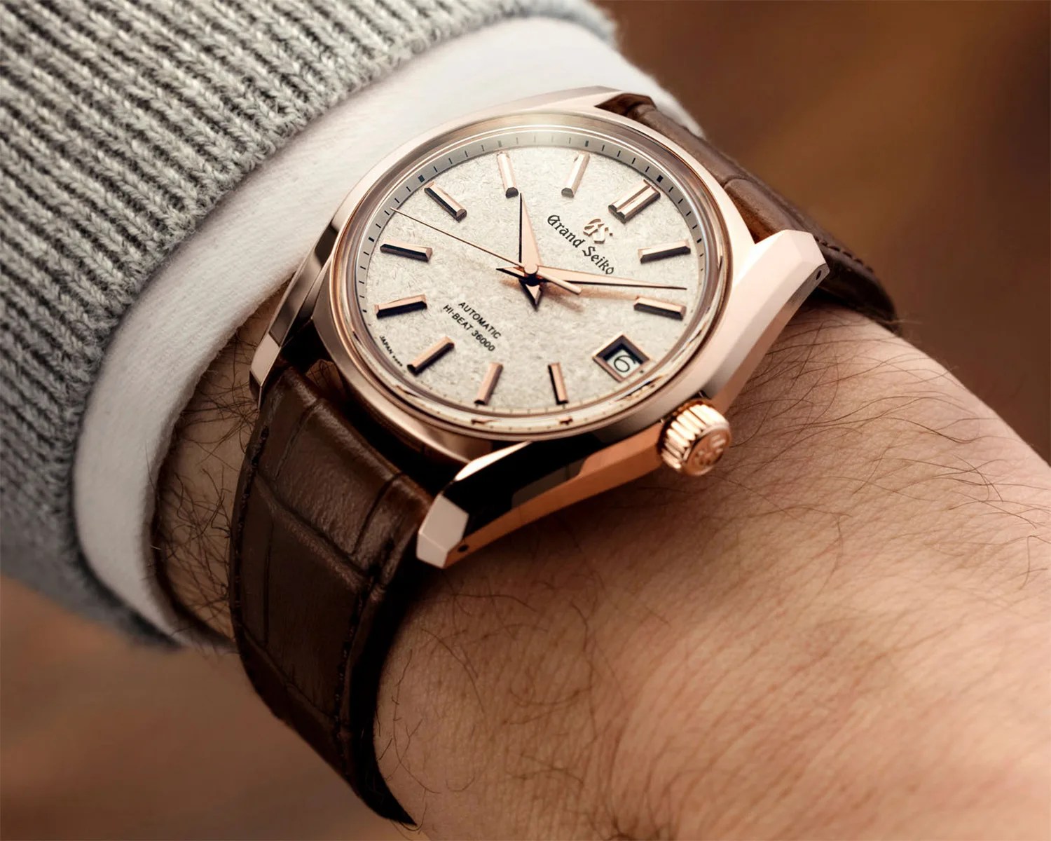 a gold grand seiko watch on a man's wrist