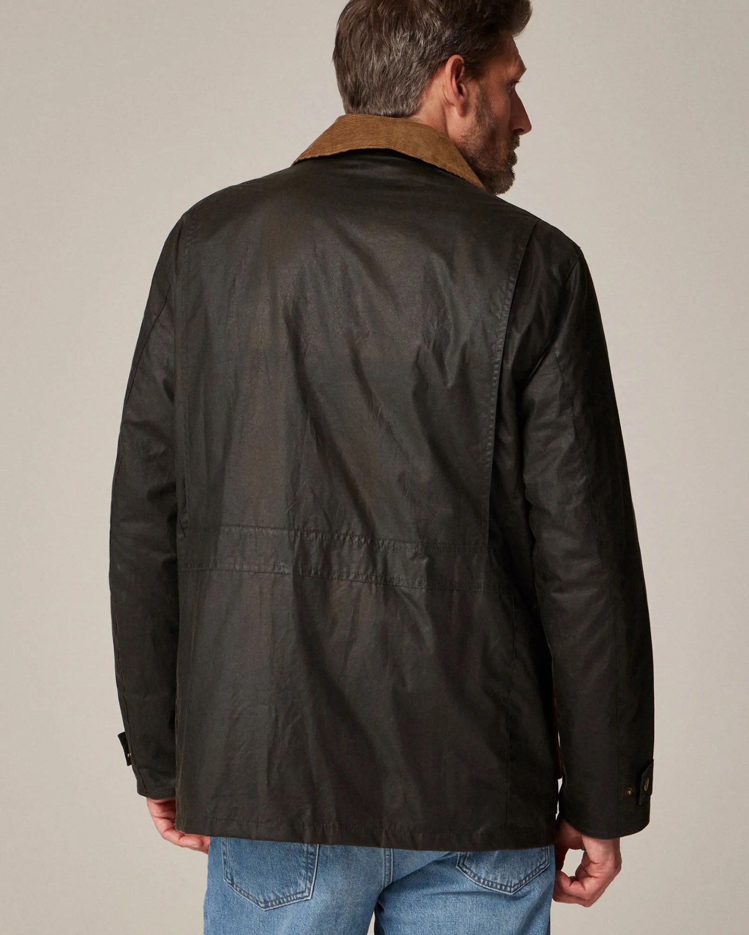 the back of a man in a green jacket