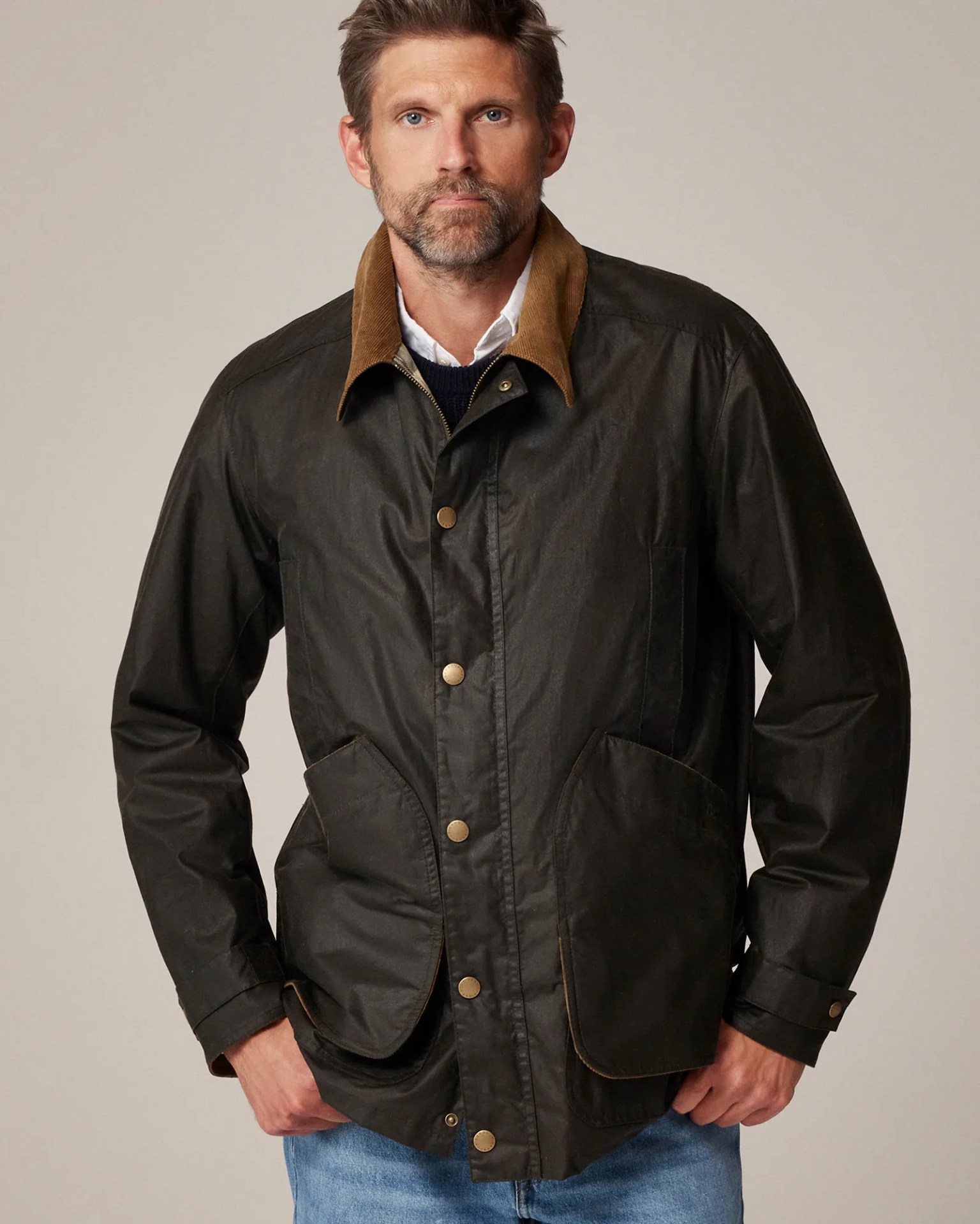 a man wearing a green barbour jacket