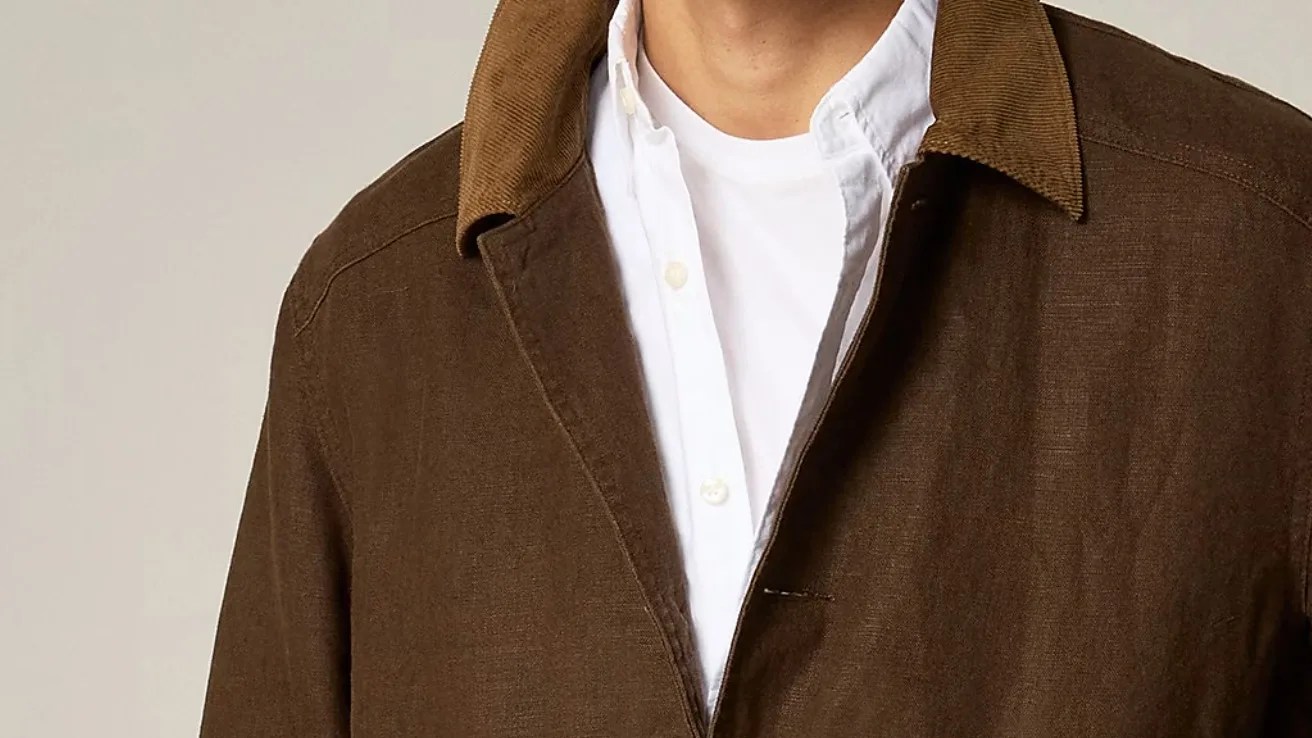 the collar and shoulders of a man in a brown jacket