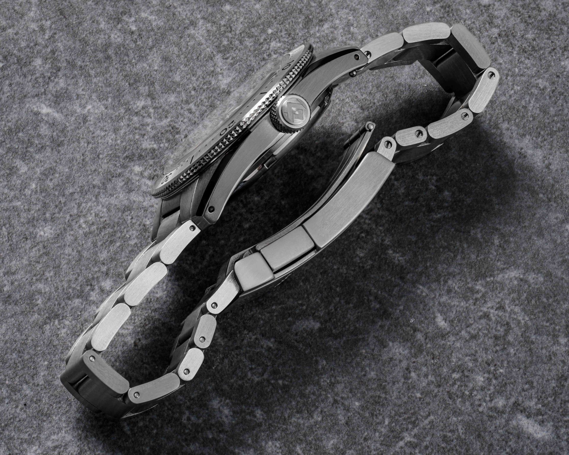 the side of a steel dive watch