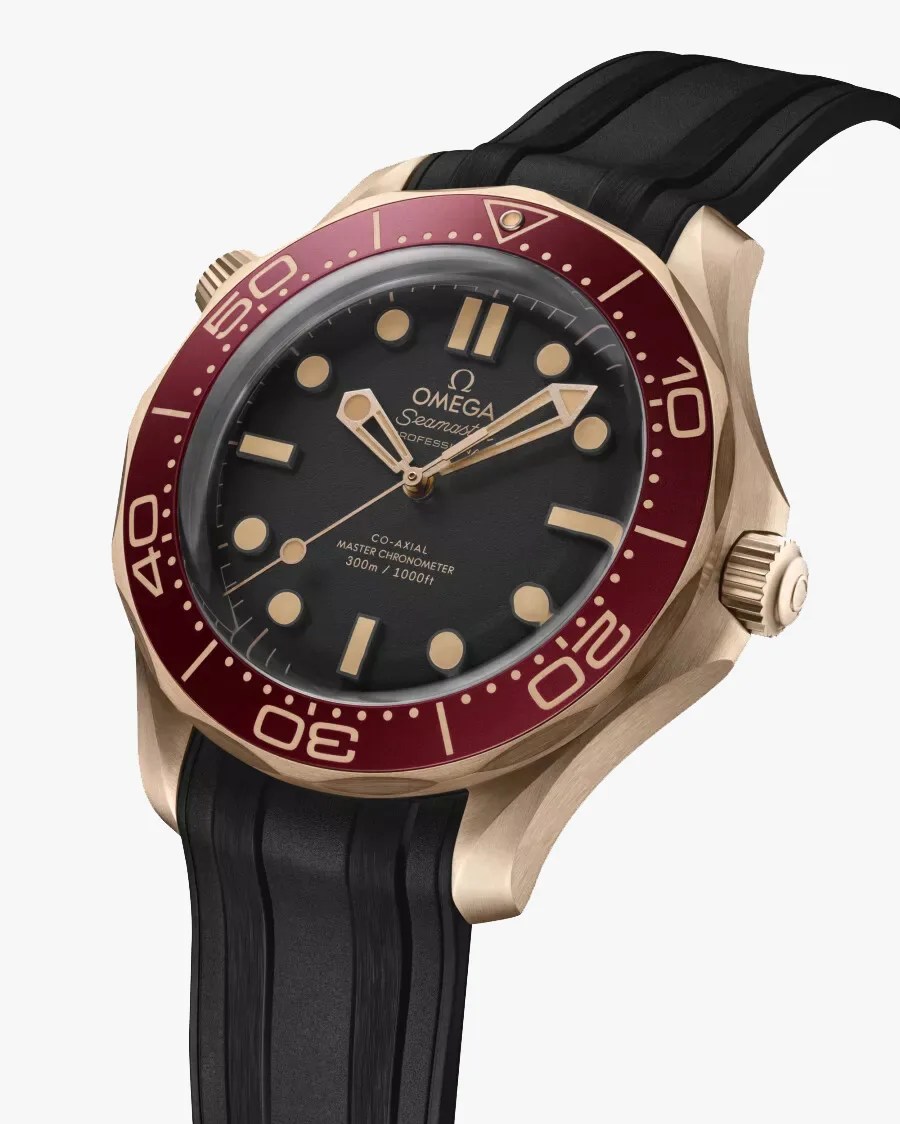a gold dive watch with a black starp