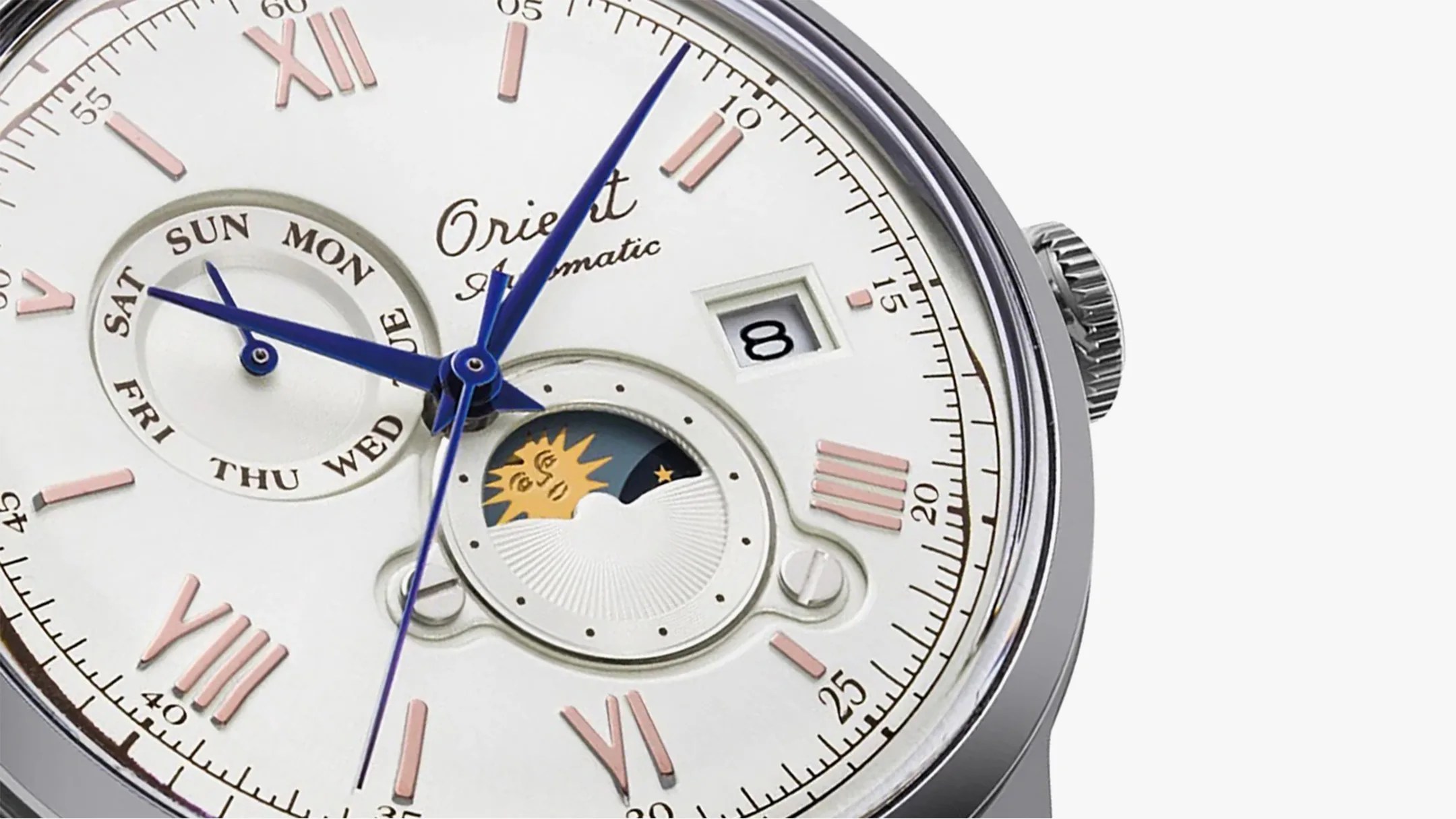 The dial of an Orient Bambino 75th Anniversary dress watch with a sun and moon window