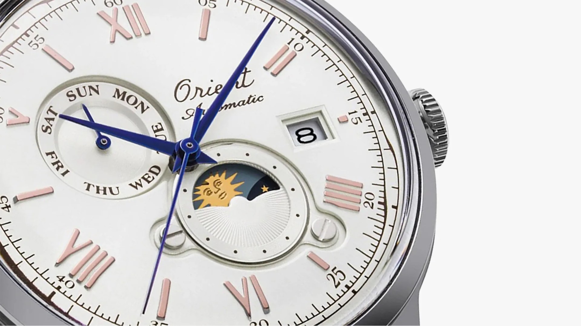 The dial of an Orient Bambino 75th Anniversary dress watch with a sun and moon window