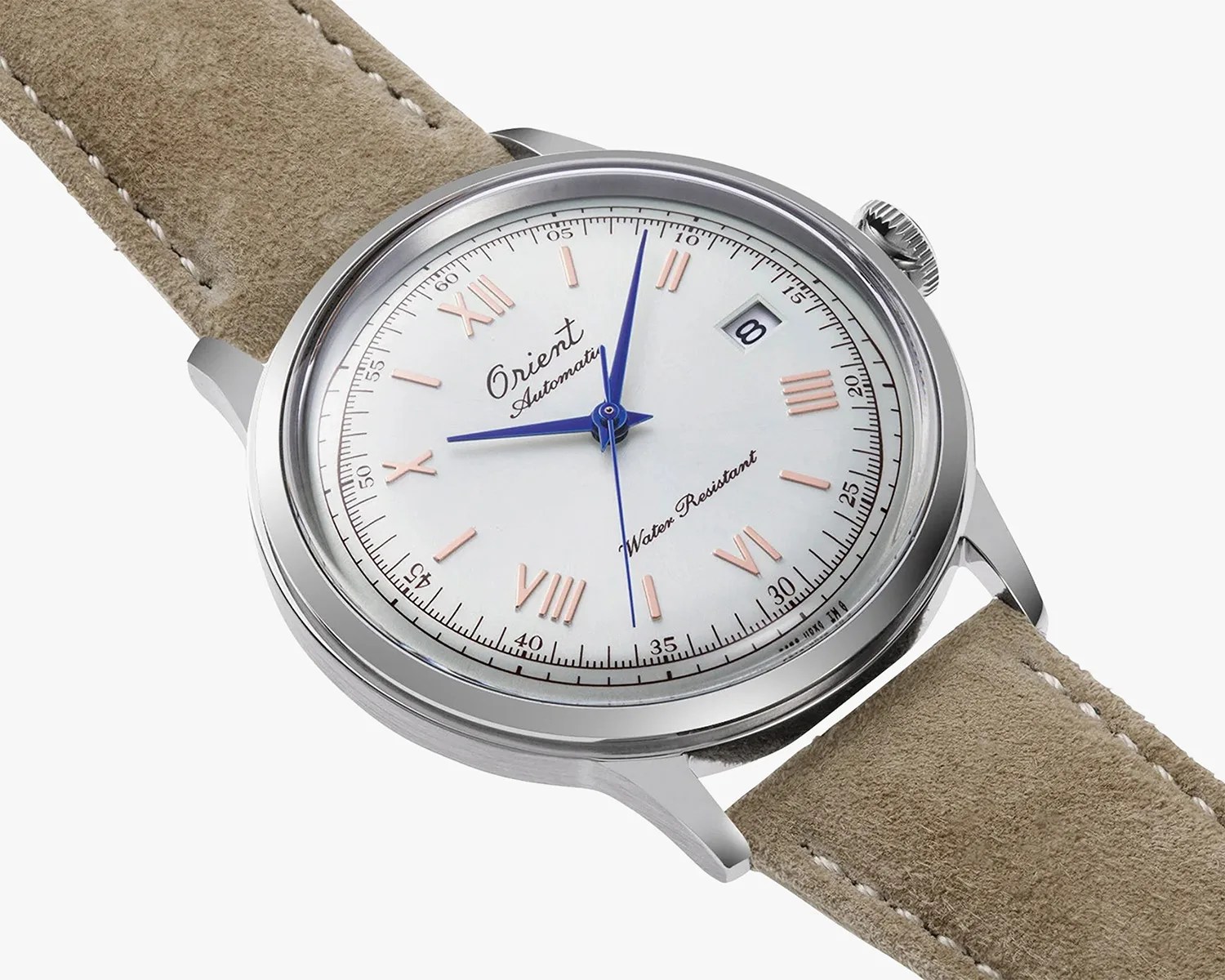 a white dial dress watch on a tan suede strap