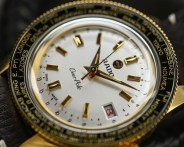 the dial of a gold watch with a silver dial