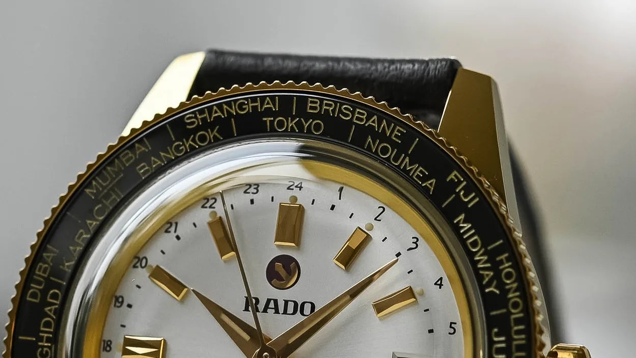 The top half of the dial and bezel of a gold Rado Captain Cook Over Pole watch