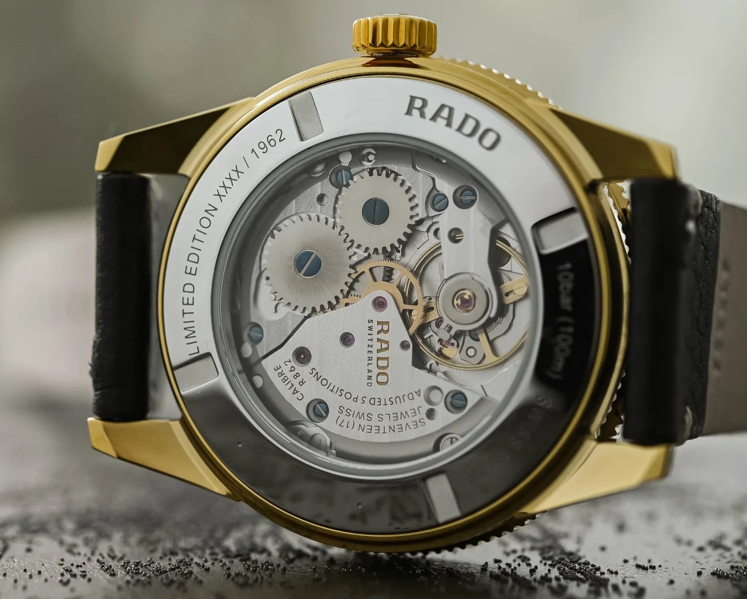 a watch with a glass case back and visible mechanical movement