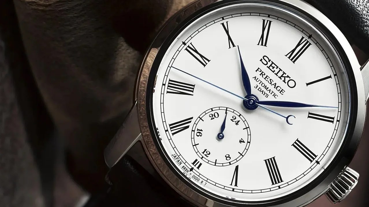 close up of a watch dial with roman numeral indices