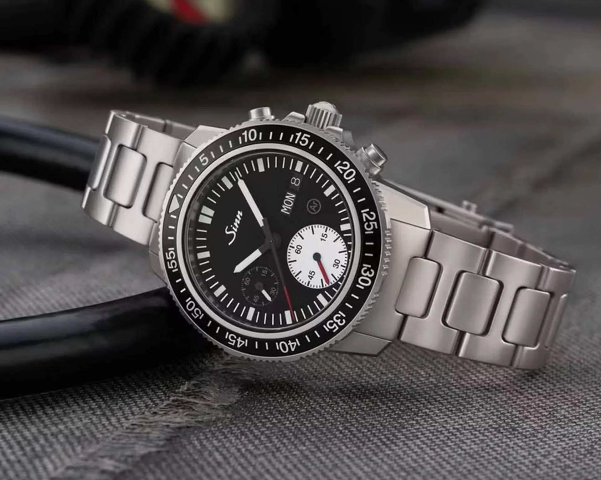 a steel Sinn dive watch with a black dial